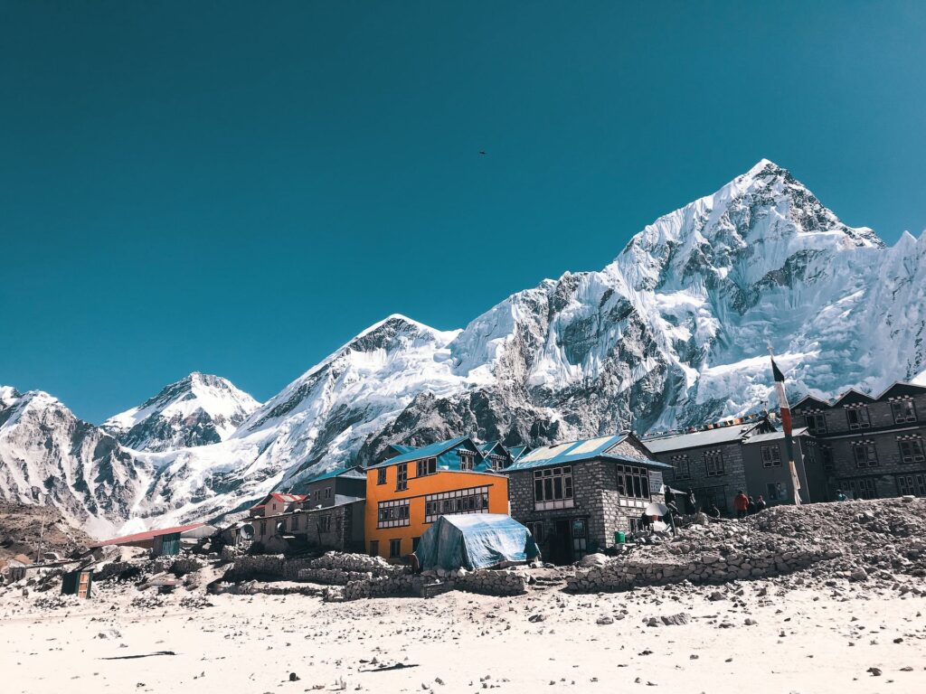 Oranžové a sivé domy v blízkosti zasneženej hory Base Camp Mount Everest.